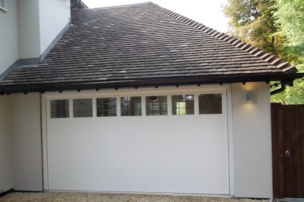 CEDAR TIMBER GARAGE DOOR WITH WINDOWS FITTED IN GUILDFORD
