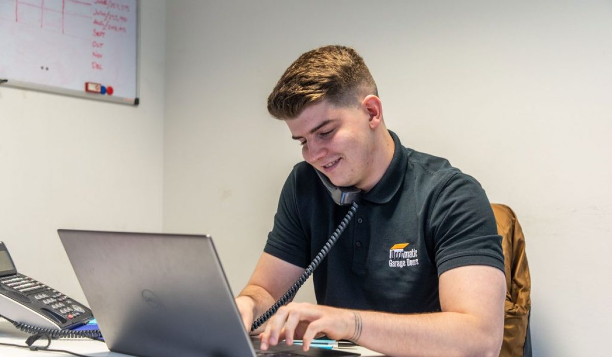 Doormatic staff smiling on phone to customer