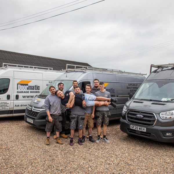 Doormatic team stood in front of vans