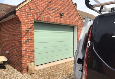 Front view of sage sectional garage door