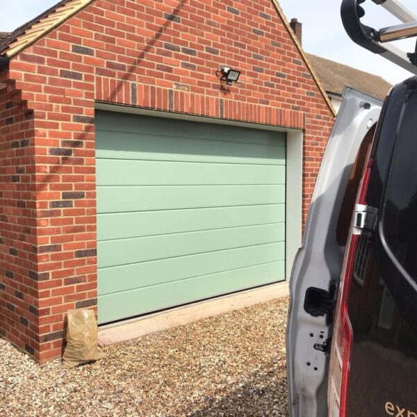 Front view of sage sectional garage door