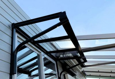 Glass entrance canopy installation on property in Surrey