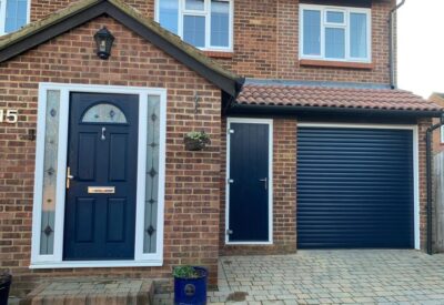 Matching garage door, side door and front door in navy blue