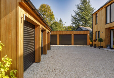 Closed black garage doors on cedar cladded building