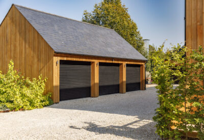 Garage doors on modern cedar wood cladded garage